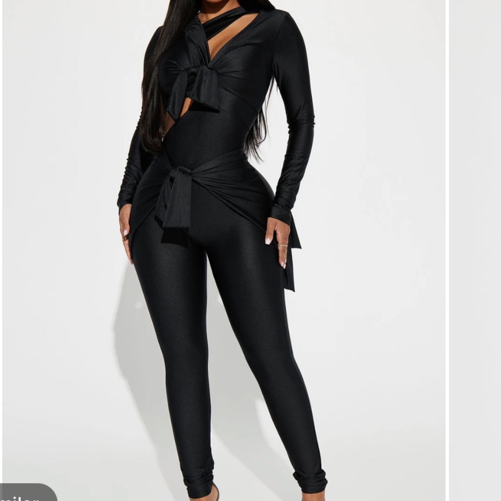 Black jumpsuit. Size small. Stretch. Cut outs. Self ties. Worn once.